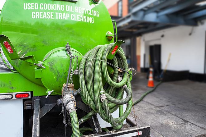 a service truck pumping grease from a restaurant's grease trap in Granada Hills